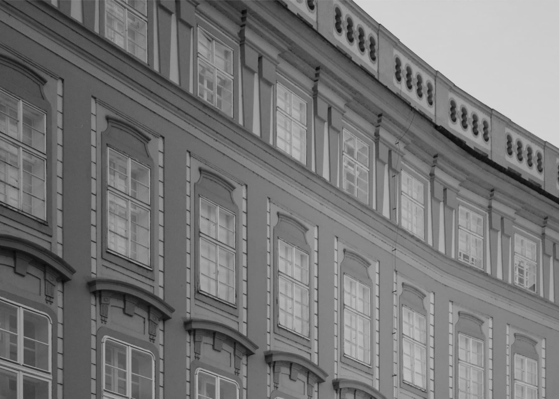 Detail of a baroque facade at Prague Castle, a long curved run of tall windows